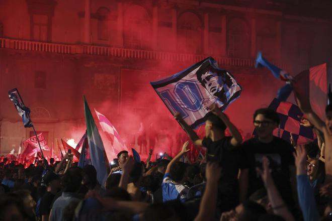 A fan holds aloft a Diego Maradona poster after Napoli won its first Serie A title since the Argentine powered the club to the Italian Scudetto in 1990.