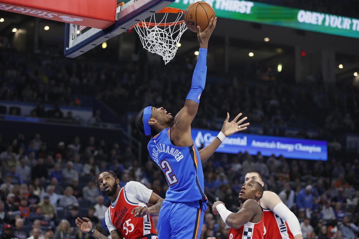 Oklahoma City Thunder guard Shai Gilgeous-Alexander (2) shoots as Los Angeles Clippers forward Derrick Jones Jr., left, guard Kris Dunn, second from right, and centre Ivica Zubac, right, watch during the first half of an NBA game in Oklahoma City.