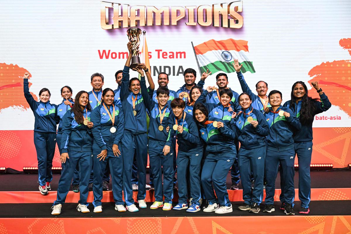 India’s women players celebrate with the trophy after winning against Thailand at the 2024 Badminton Asia Team Championships.