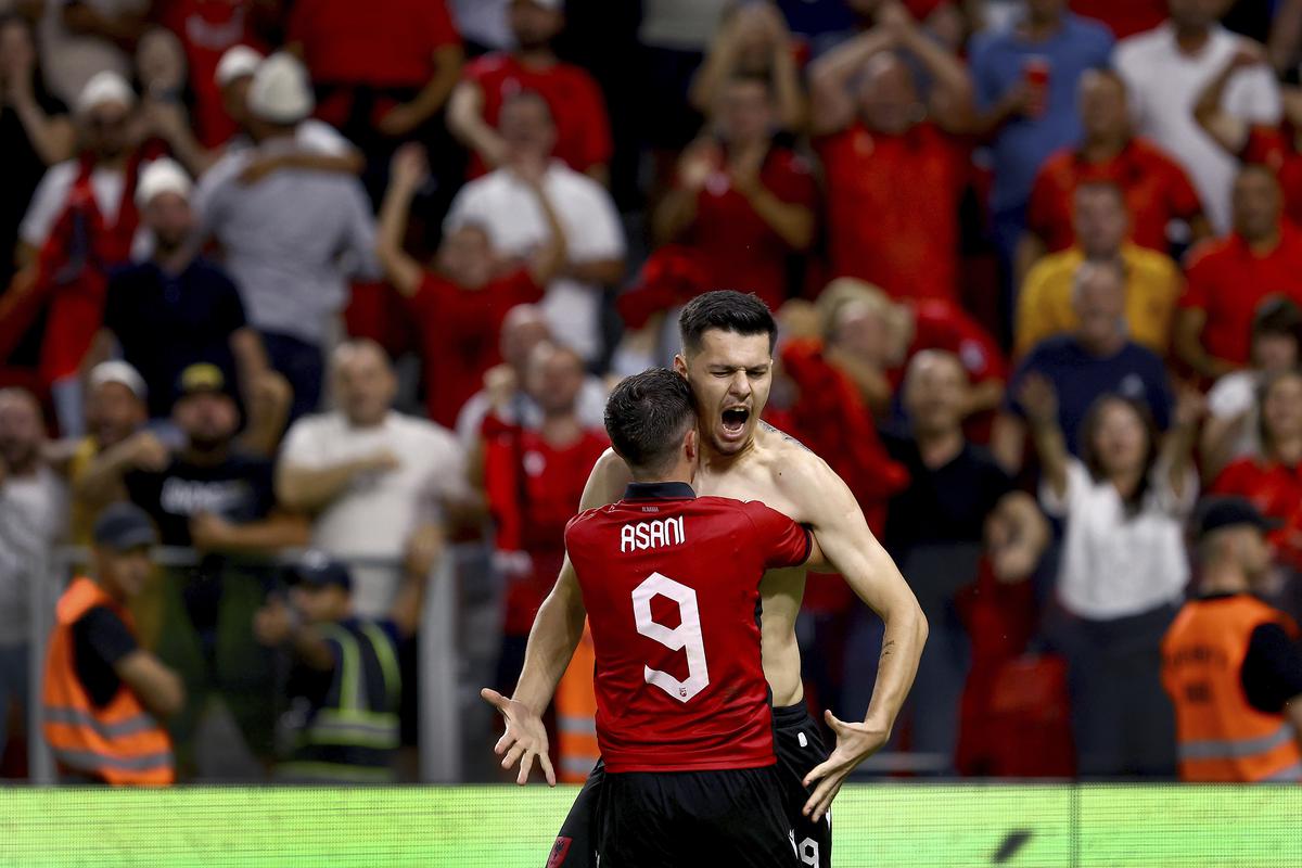 Albania’s scorer Mirlind Daku, right, and his teammate Albania’s Jasir Asani, left, celebrate their side’s second goal. 