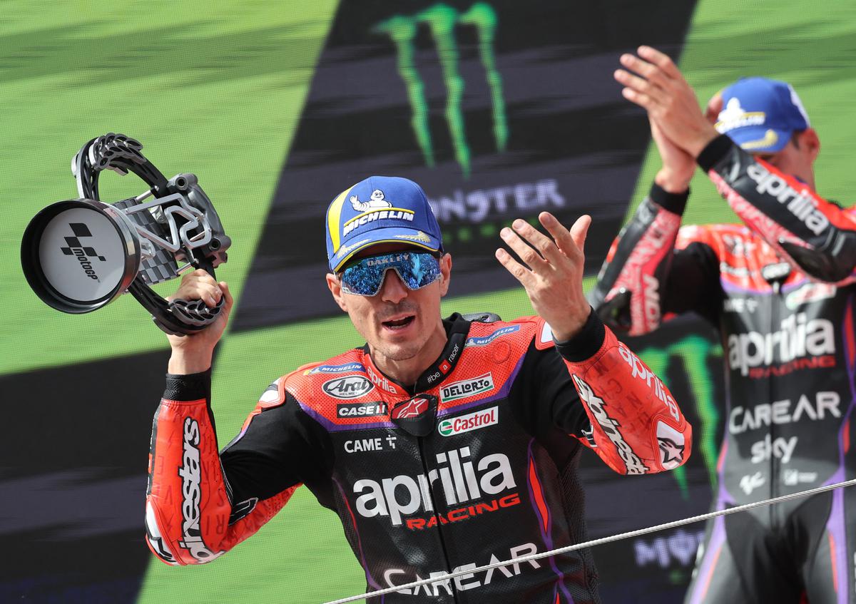 FILE PHOTO: Aprilia Racing’s Maverick Vinales celebrates on the podium with a trophy after finishing second place in the MotoGP race at Catalunya.