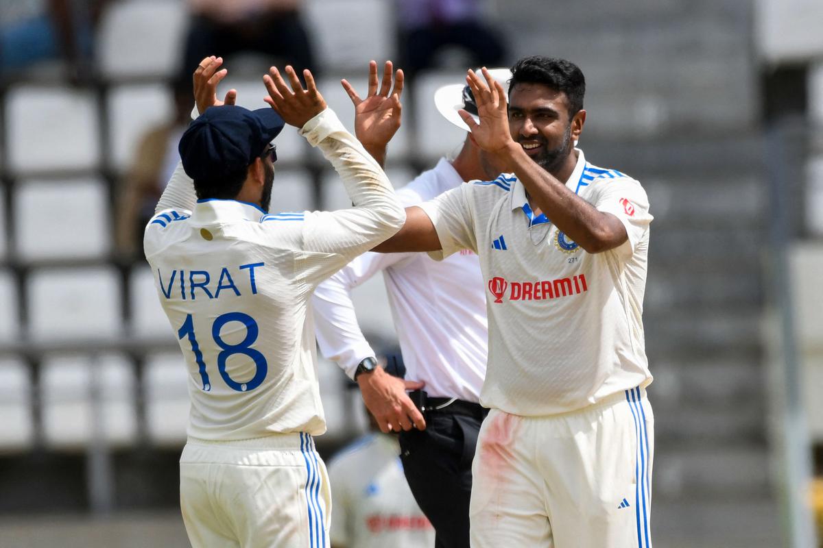 Ravichandran Ashwin (R) and Virat Kohli (L) of India celebrates the dismissal of Alzarri Joseph of West Indies during day one of the First Test. 