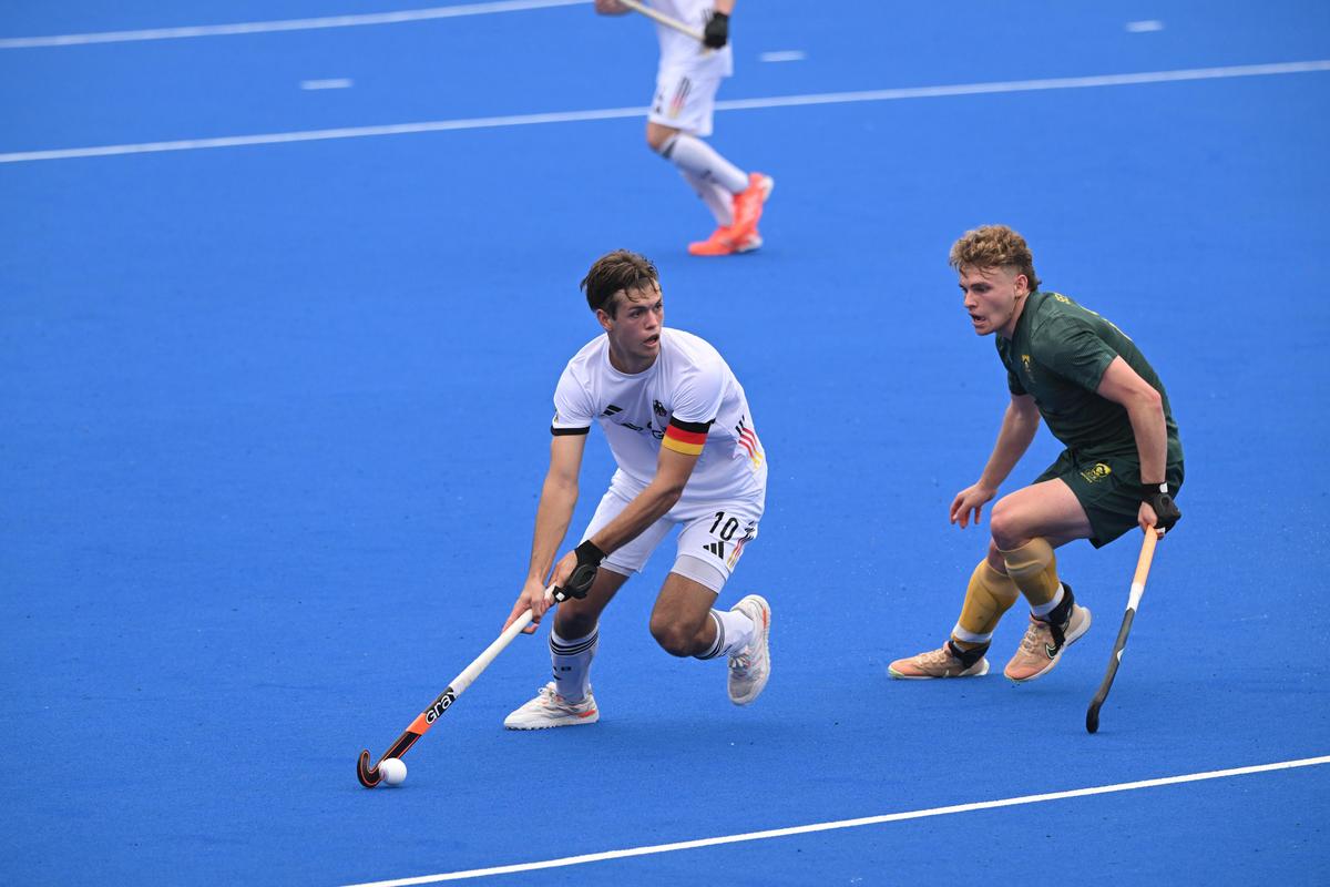 Germany's Paul Glander (in white) in action against Canada at the Madurai International Hockey Stadium.