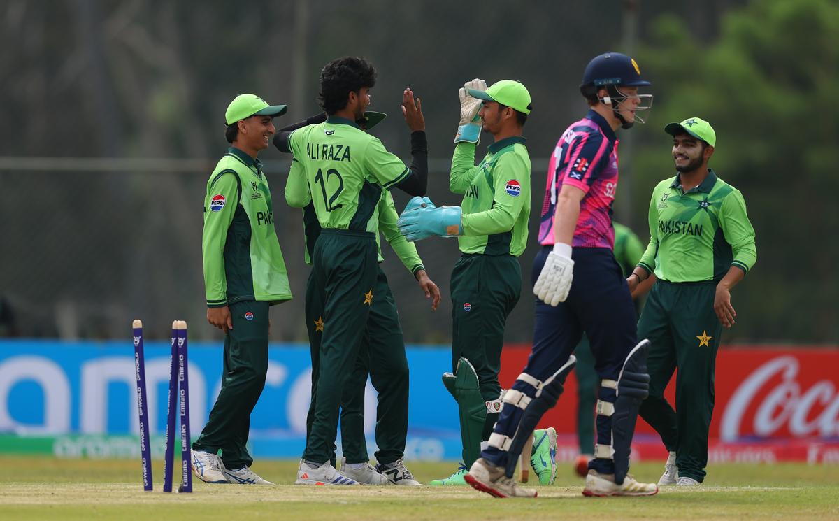 Pakistan players celebrate the wicket of Theo Robinson of Scotland.