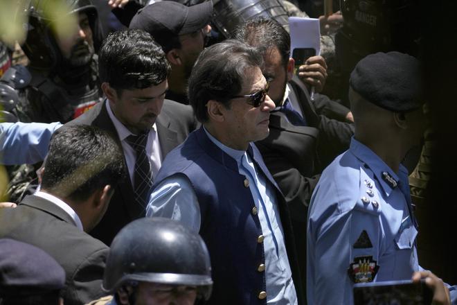 Pakistan’s former Prime Minister Imran Khan, center, was recently arrested in a graft case but a High Court granted him bail and a two-week reprieve.