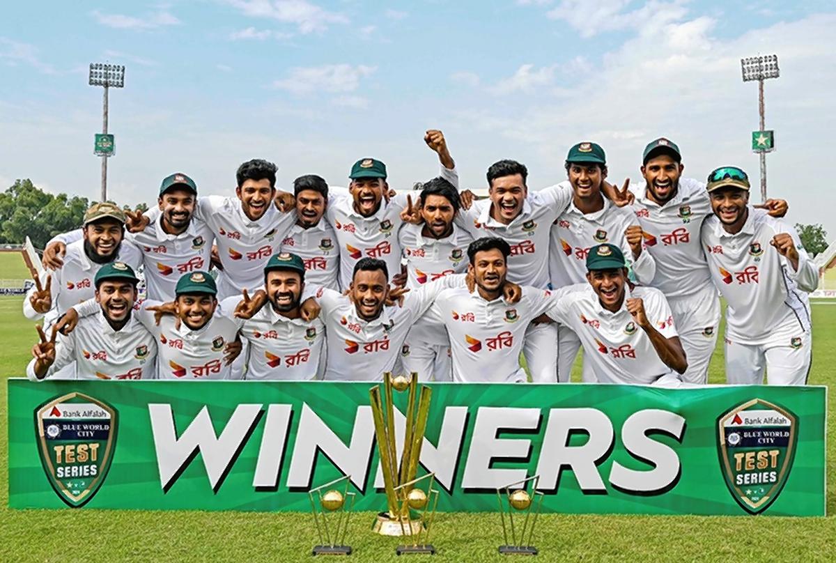 Bangladesh’s players celebrate with trophy after winning the second and last Test cricket match between Pakistan and Bangladesh.