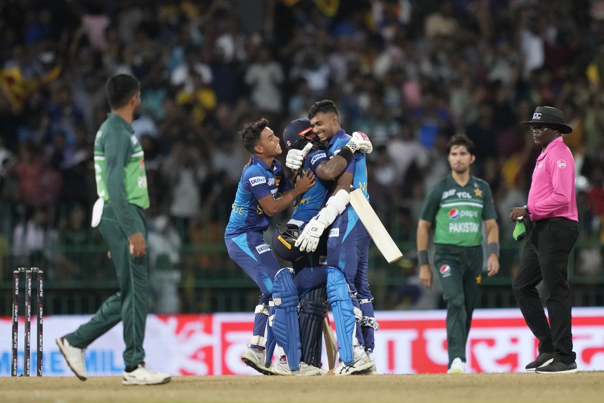 Sri Lanka’s Charith Asalanka is embraced by Dunith Wellalage and Matheesha Pathirana as they celebrate their two-wicket win over Pakistan. 
