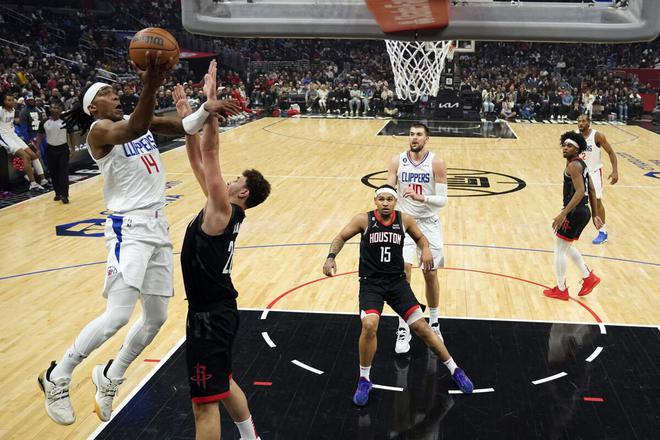 Los Angeles Clippers guard Terance Mann scores over Houston Rockets center Alperen Sengun. 