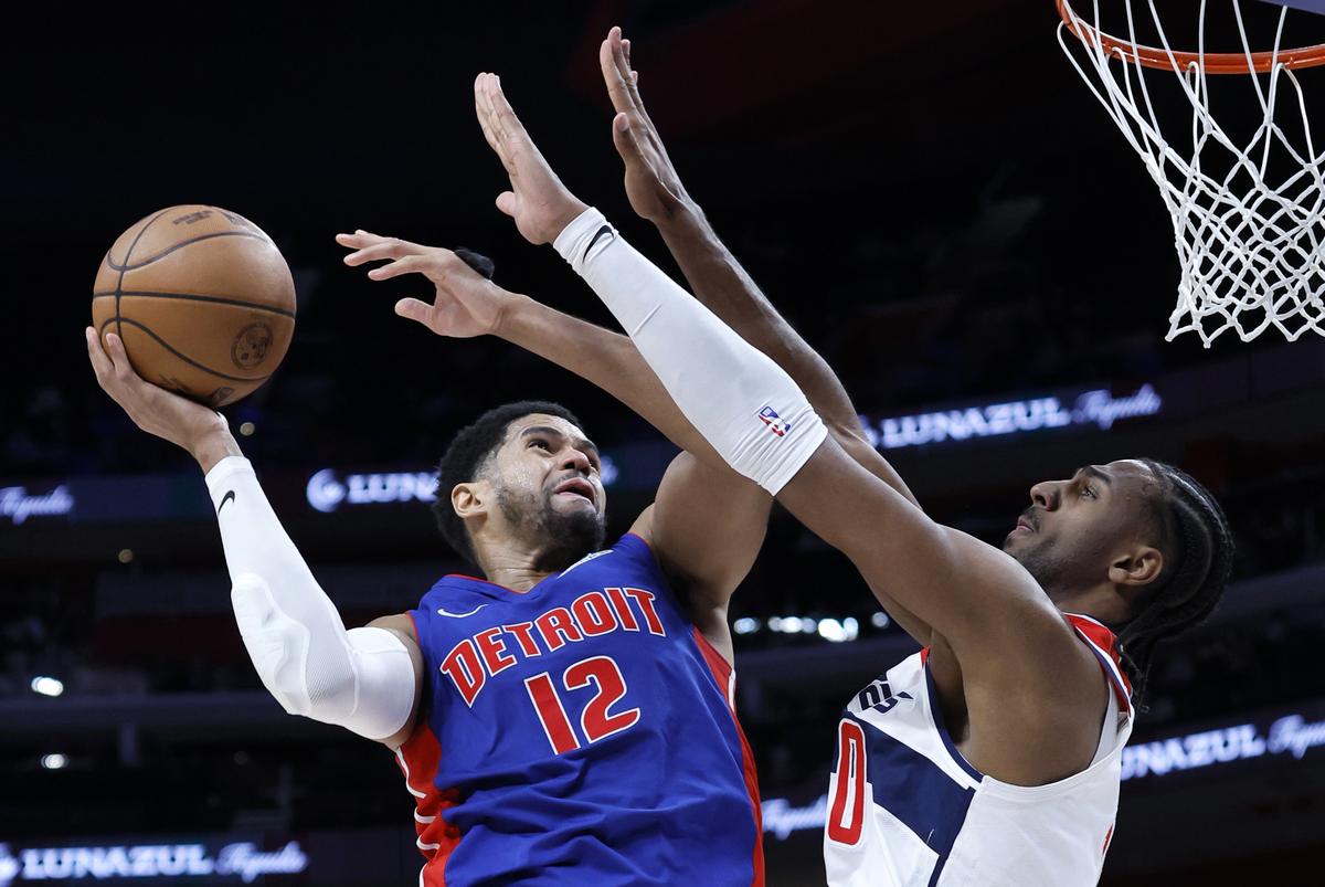 Detroit Pistons forward Tobias Harris (12) goes to the basket against Washington Wizards forward Alex Sarr, right, during the second half of an NBA basketball game.