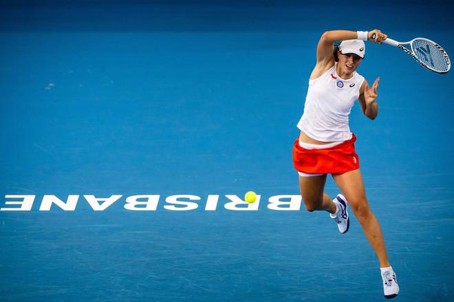 Poland’s Iga Swiatek hits a return to Kazakhstan’s Yulia Putintseva during their women’s singles match of the United Cup tennis tournament.
