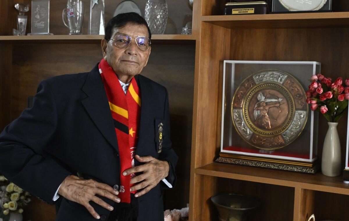 Syed Nayeemuddin, former coach and captain of the Indian football team, poses with his Arjuna Award at his residence in Hyderabad. 