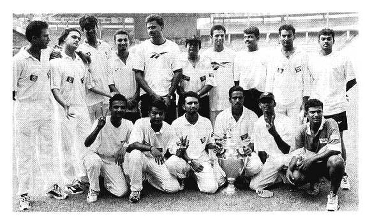 The victorious Karnataka team with the Ranji Trophy it won in Bangalore in 1998