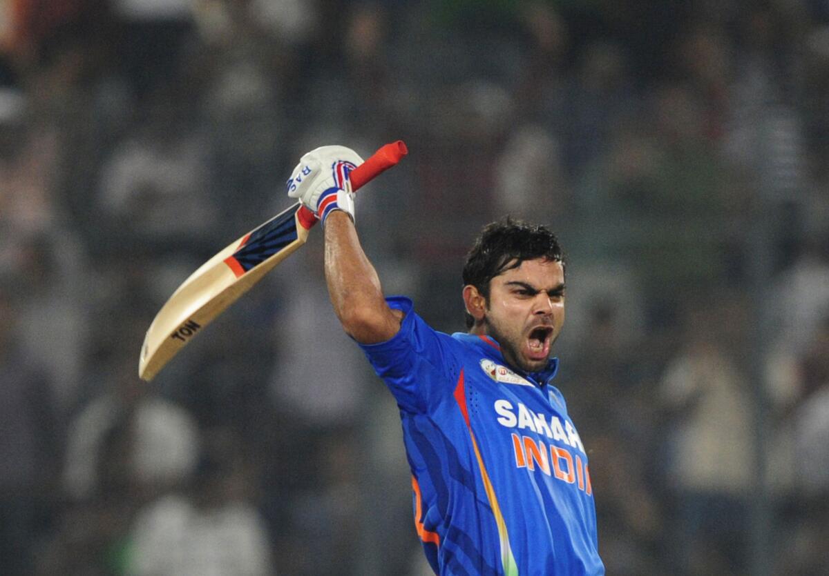 Virat Kohli reacts after scoring a century during the Asia Cup match against Pakistan at the Sher-e-Bangla National Cricket Stadium in Dhaka on March 18, 2012.