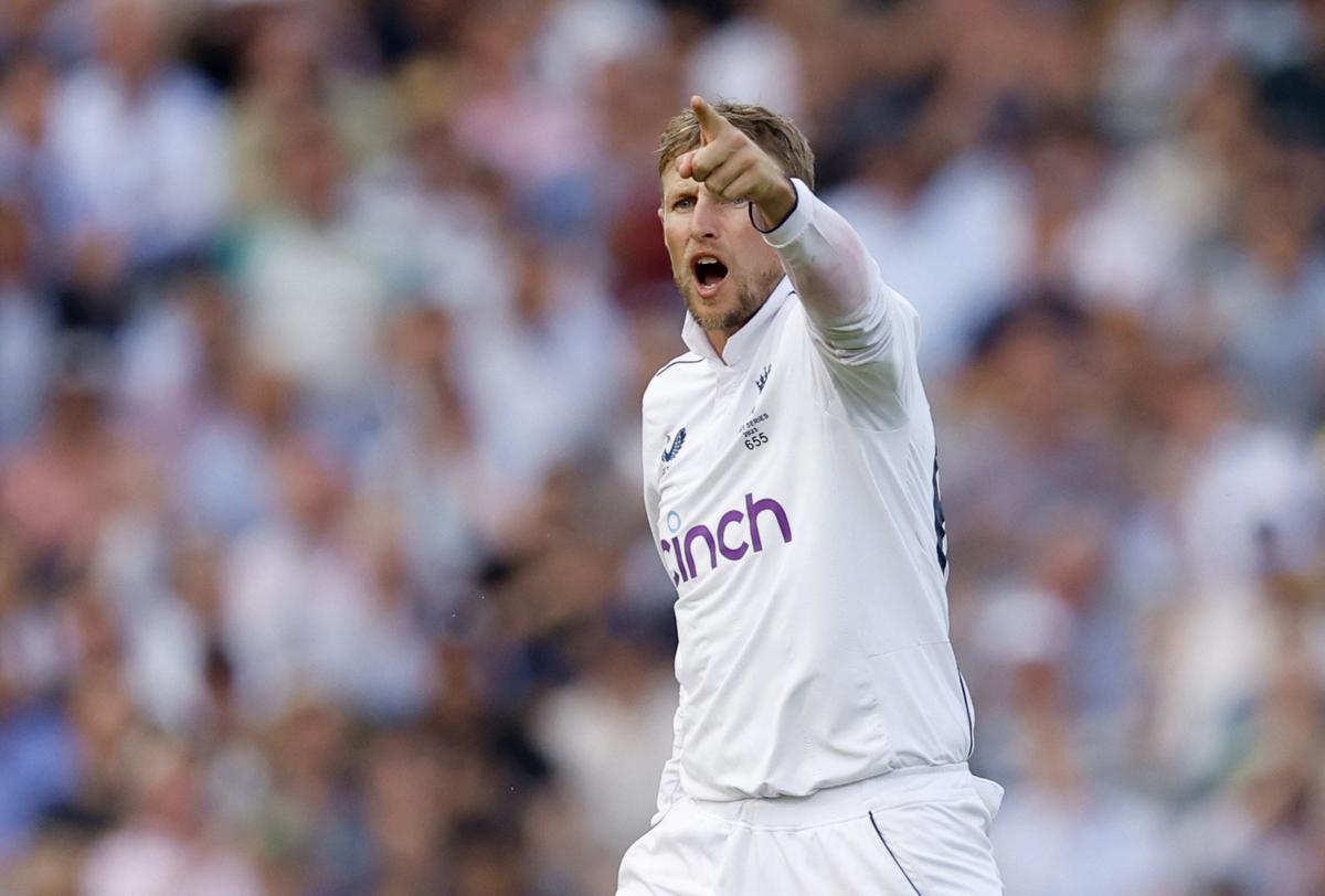 England’s Joe Root celebrates after taking the wicket of Australia’s Travis Head, stumped by Jonny Bairstow. 