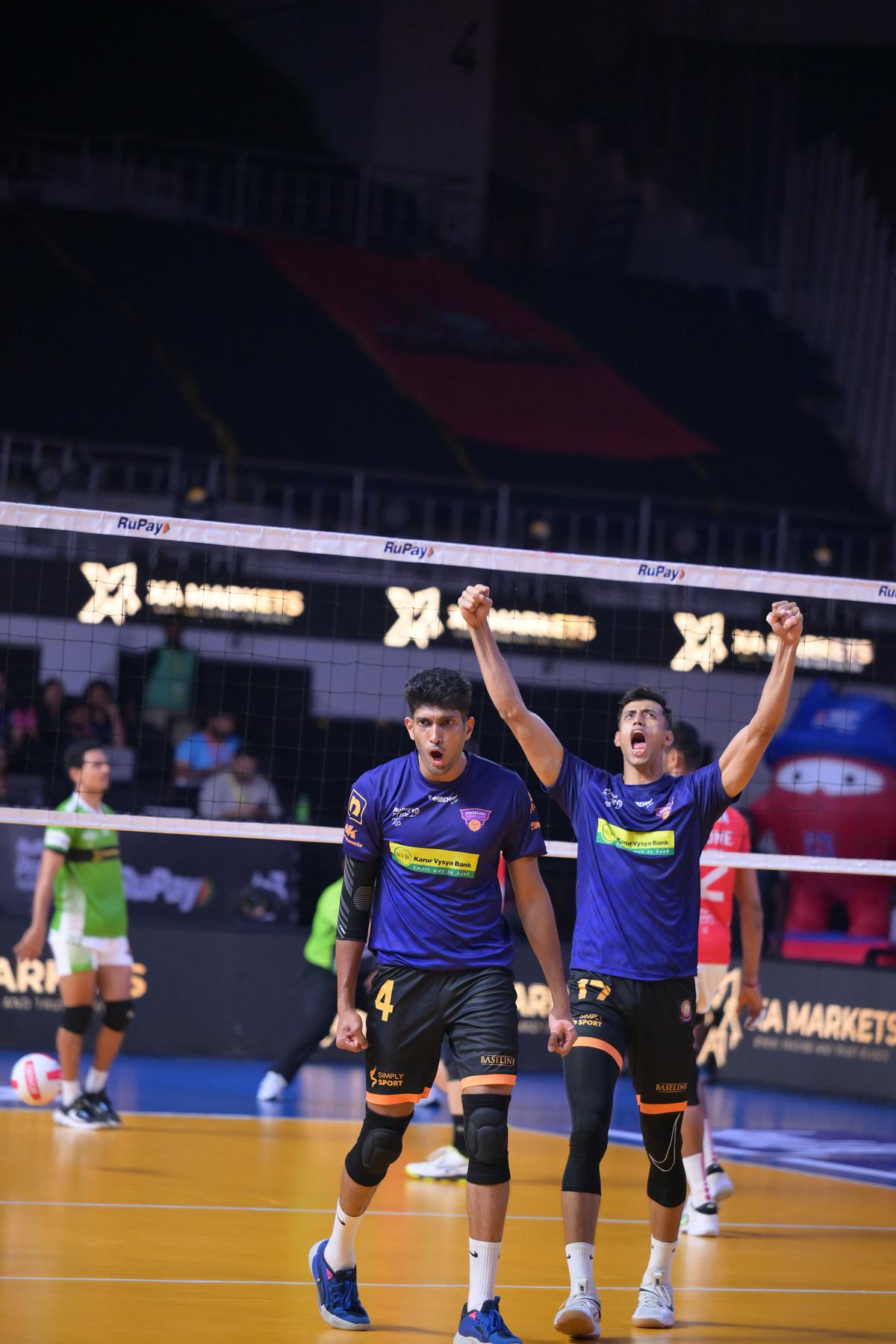 Ibin Jose (L) celebrates after winning a point.