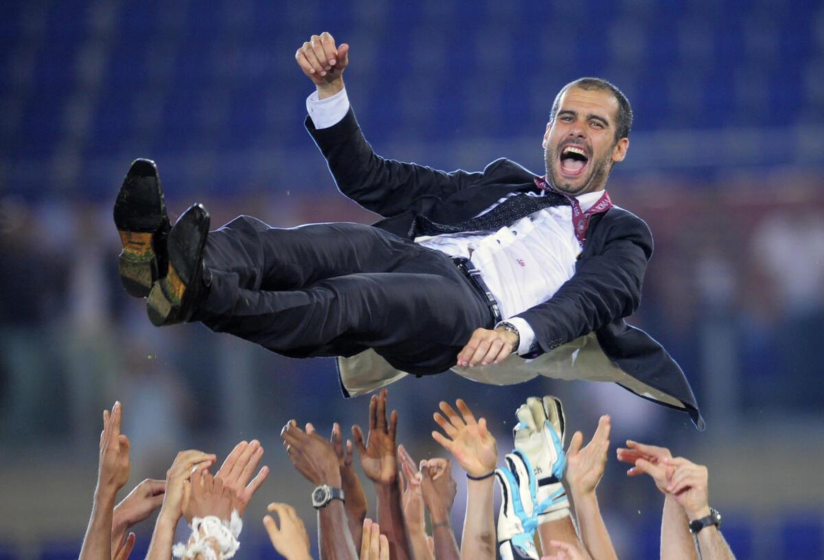 Barcelona coach Pep Guardiola is thrown in the air in celebration after his side won the Champions League final against Manchester United in Rome on May 27, 2009.