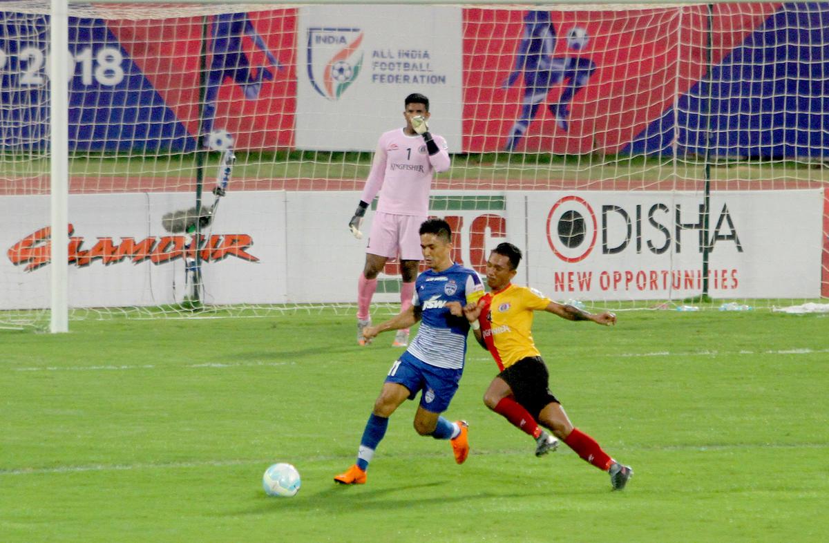 Bengaluru FC’s captain Sunil Chhetri (Blue) and an East Bengal player fight for possession of the ball during the Super Cup 2018 final.