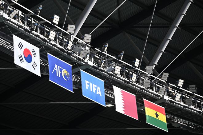 The South Korean, AFC, FIFA , Qatari, and Ghanaian flags are seen prior match. 