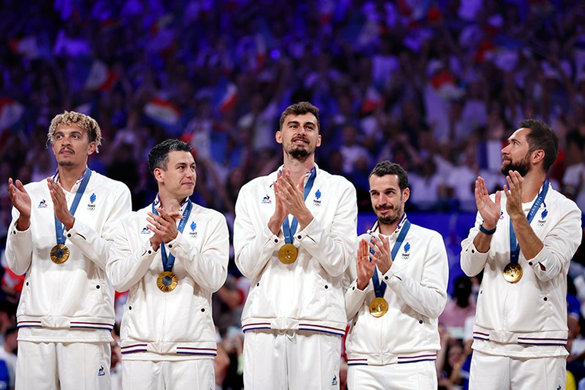 Gold medalists of Team France applaud on the podium during the Volleyball medal ceremony after the Men’s Gold Medal Match on Day fifteen of the Olympic Games Paris 2024 at Paris Arena on August 10, 2024 in Paris, France. 