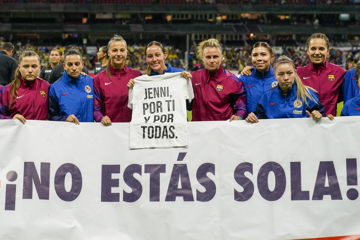 Players of Mexico’s America and Spain’s Barcelona, hold a banner that reads in Spanish “You are not alone,” and a T-shirt that reads “Jenni for you and all of us,” in support of Spain’s Jennifer Hermoso, before a friendly match at Azteca stadium in Mexico City, Tuesday, Aug. 29, 2023.