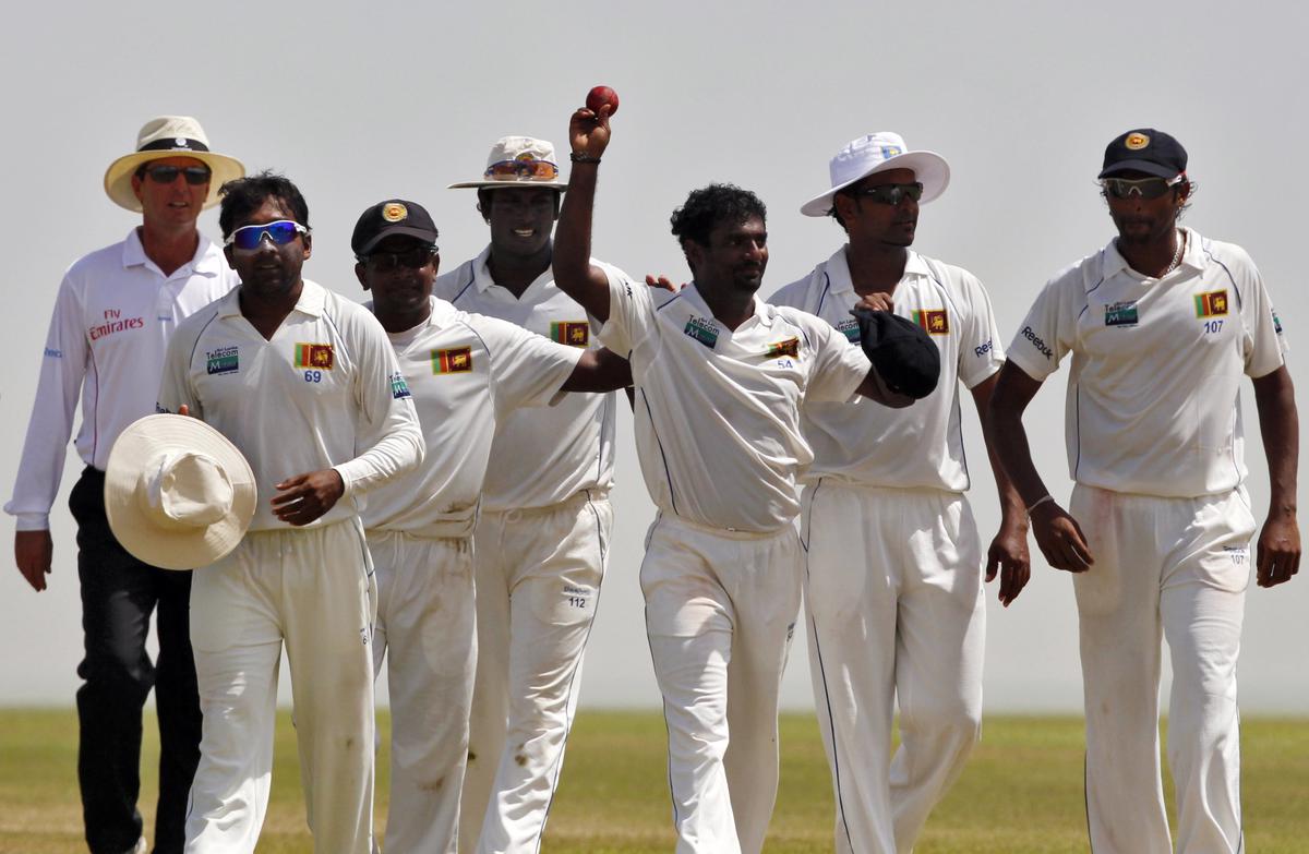 Above the rest: Sri Lanka’s Muttiah Muralitharan (3rd R) shows the ball after he took his 800th wicket during the fifth day of their first Test against India in Galle July 22, 2010. He remains the highest wicket-taker in the format till date.