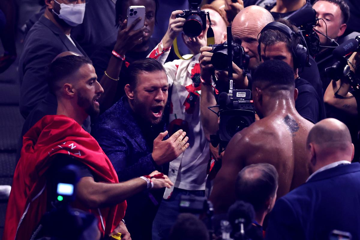 Conor McGregor celebrates victory with Anthony Joshua after he knocked out Robert Helenius.