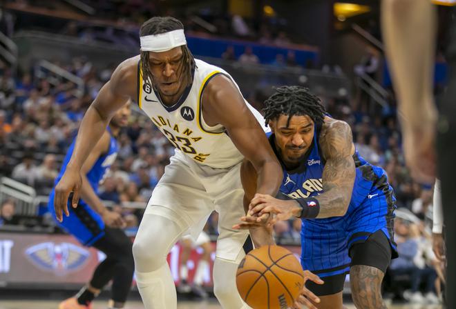 Indiana Pacers centre Myles Turner (33) and Orlando Magic guard Gary Harris, right, fight for the ball during the second half of an NBA basketball game Saturday, Feb. 25, 2023, in Orlando. 