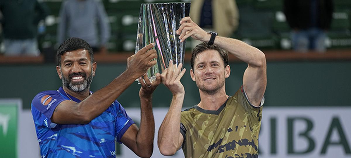 Rohan Bopanna, of India, left, and teammate Matthew Ebden, of Australia, hold up the winner’s trophy at the BNP Paribas Open in Indian Wells.