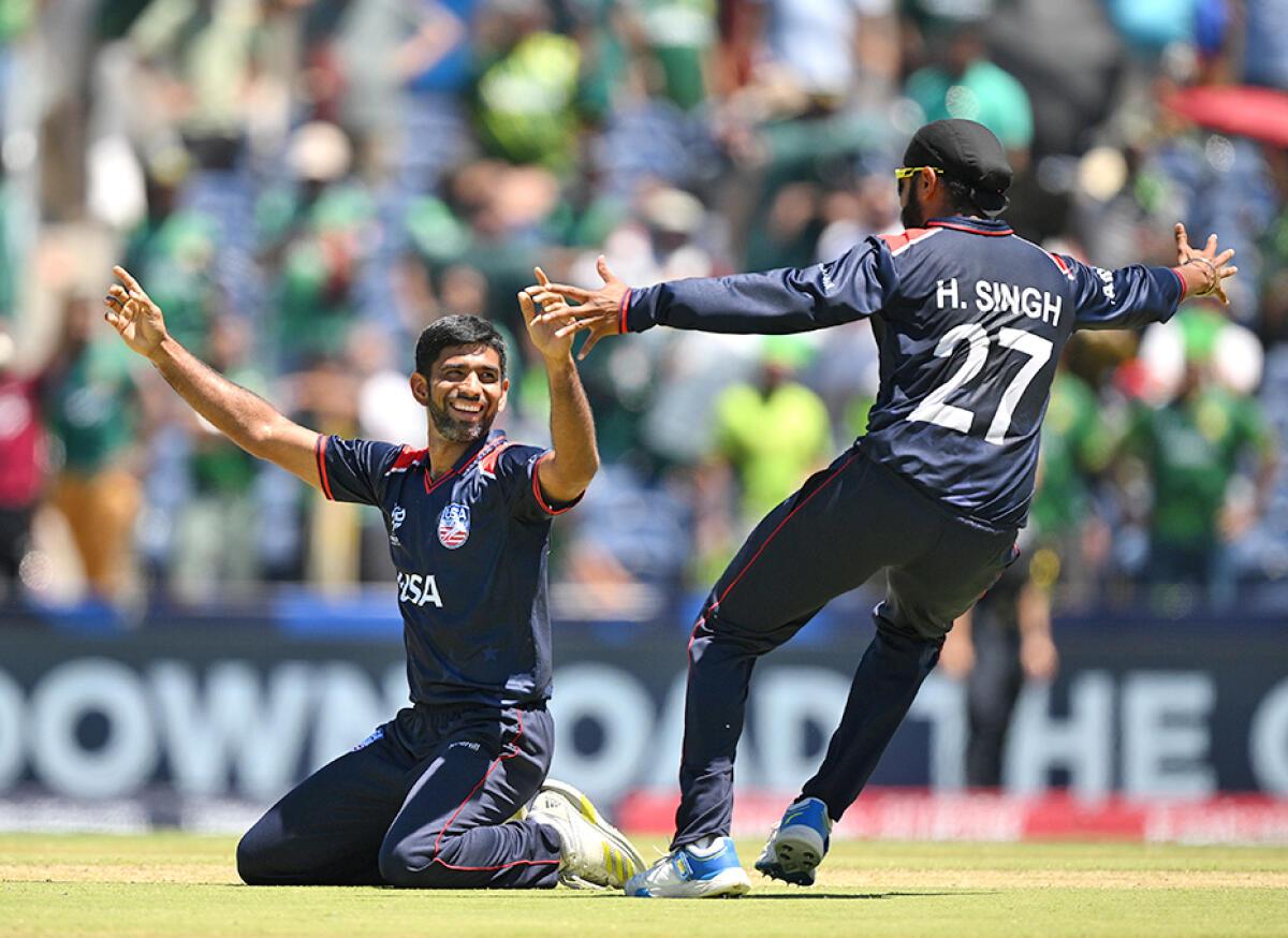 Saurabh Netravalkar of USA celebrates with teammate Harmeet Singh after USA defeats Pakistan. 