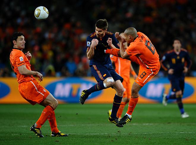 Nigel De Jong of the Netherlands kicks Xabi Alonso of Spain during the FIFA World Cup Final at Soccer City Stadium on July 11, 2010 in Johannesburg, South Africa. 