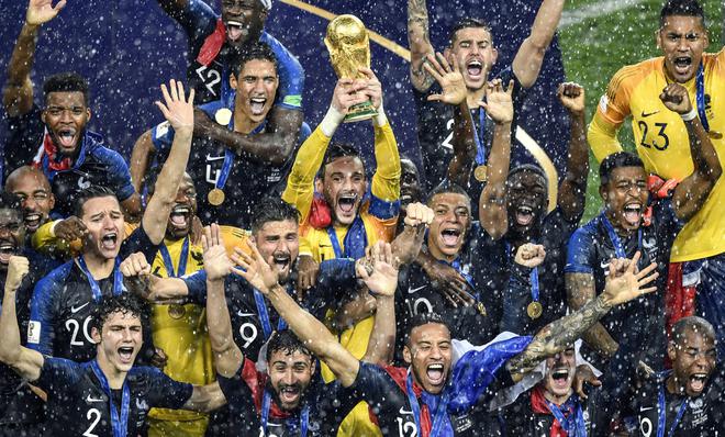 (FILES) This file photo taken on July 15, 2018, shows France’s goalkeeper Hugo Lloris holding the trophy as he celebrates with teammates during the trophy ceremony at the end of the Russia 2018 World Cup final football match between France and Croatia at the Luzhniki Stadium in Moscow.