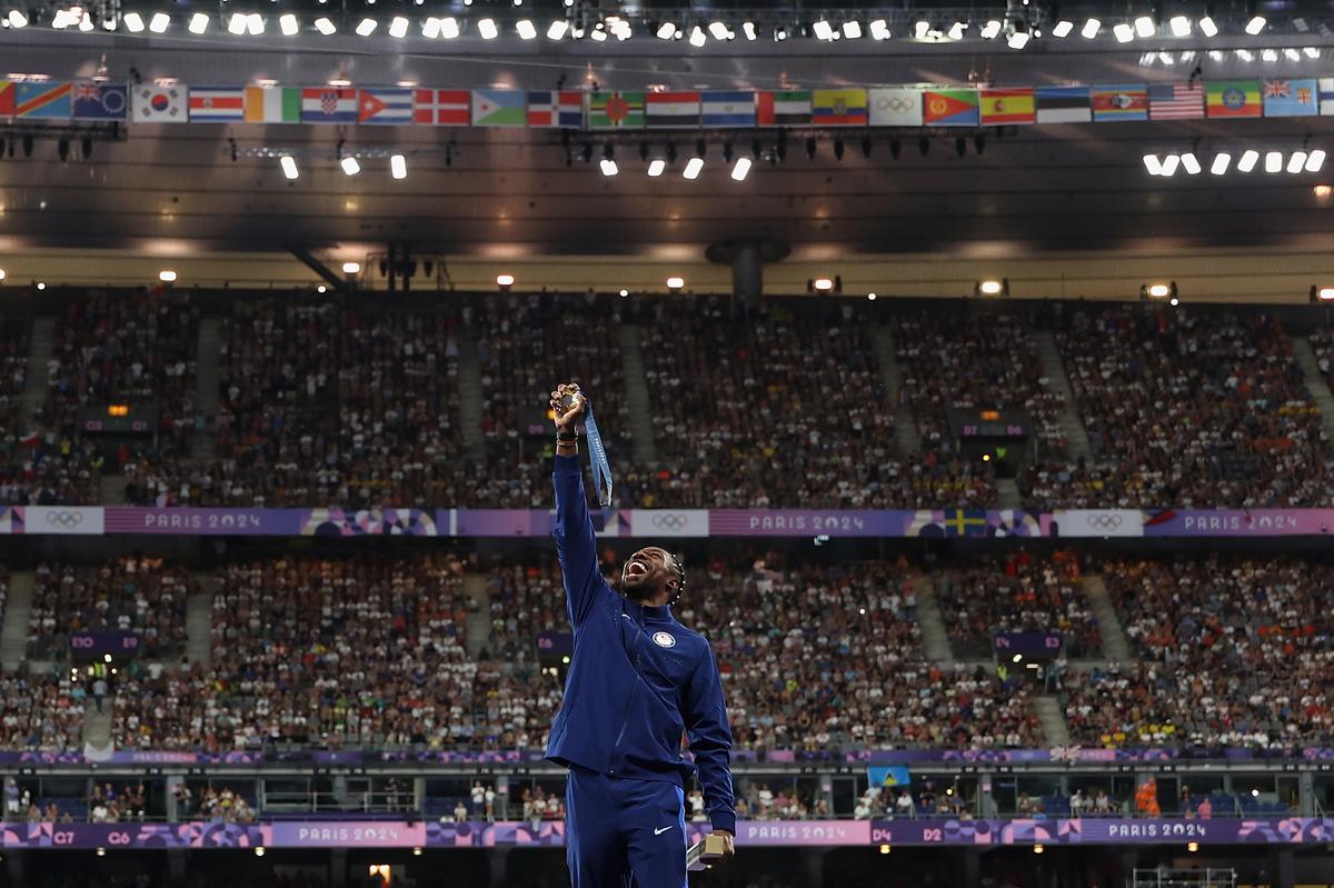 Gold medalist Noah Lyles of Team United States celebrates on the podium during the Men’s 100m medal ceremony