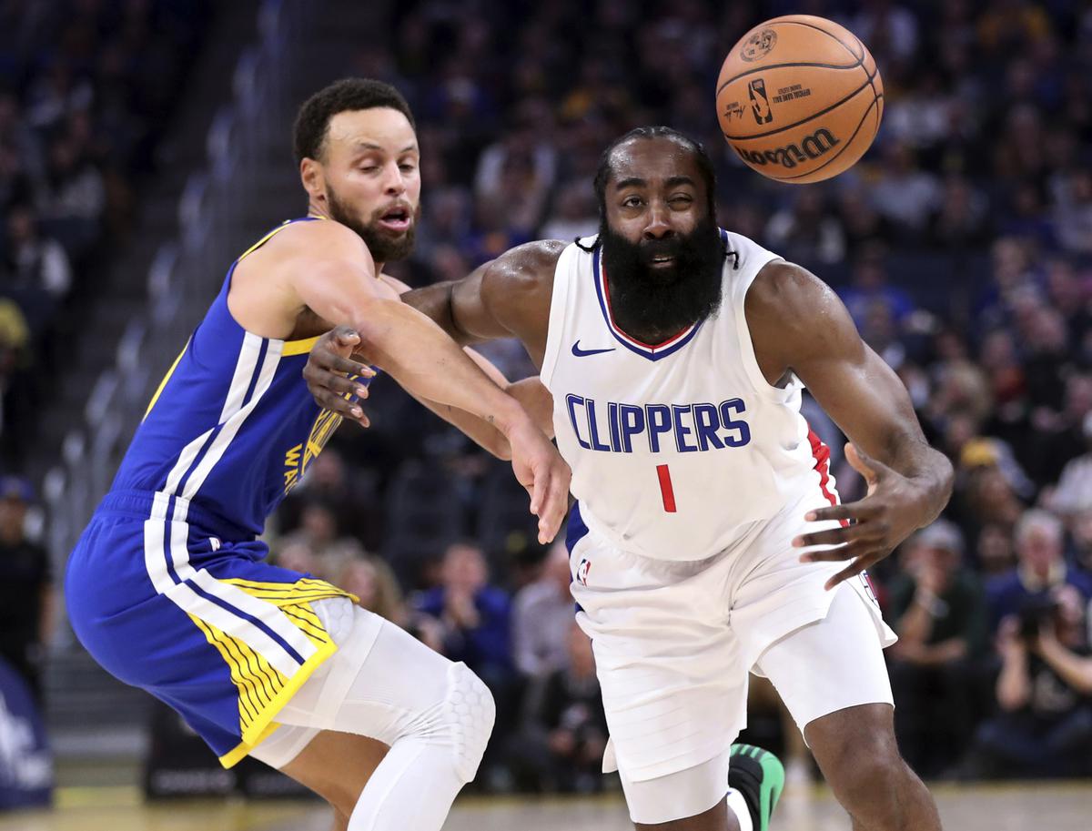 Los Angeles Clippers’ James Harden loses control of the ball next to Golden State Warriors’ Stephen Curry during the first quarter of an NBA basketball game Thursday, Nov. 30, 2023, in San Francisco.