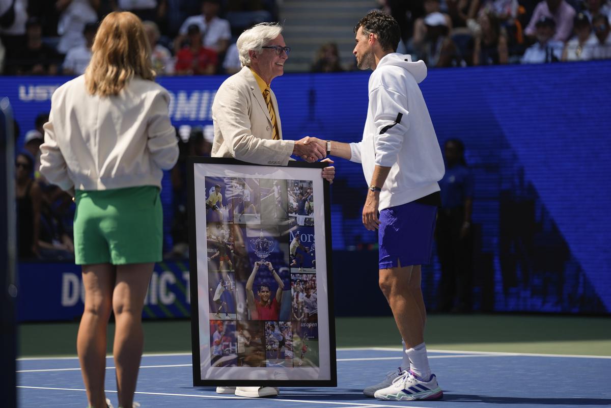 Dominic Thiem, of Austria, is presented with a collage of photos of his play at the U.S. Open.