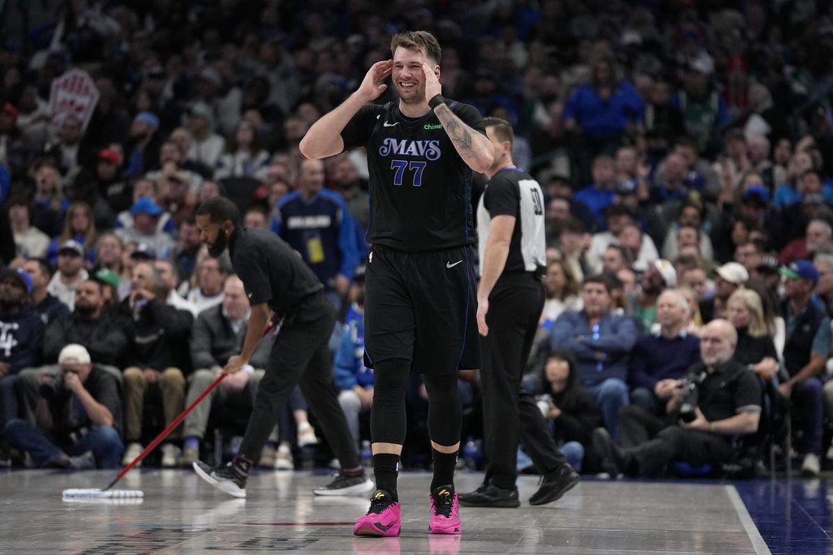 Dallas Mavericks guard Luka Doncic (77) smiles as he walks up court during the second half of an NBA basketball game against the Houston Rockets in Dallas, Tuesday, Nov. 28, 2023.