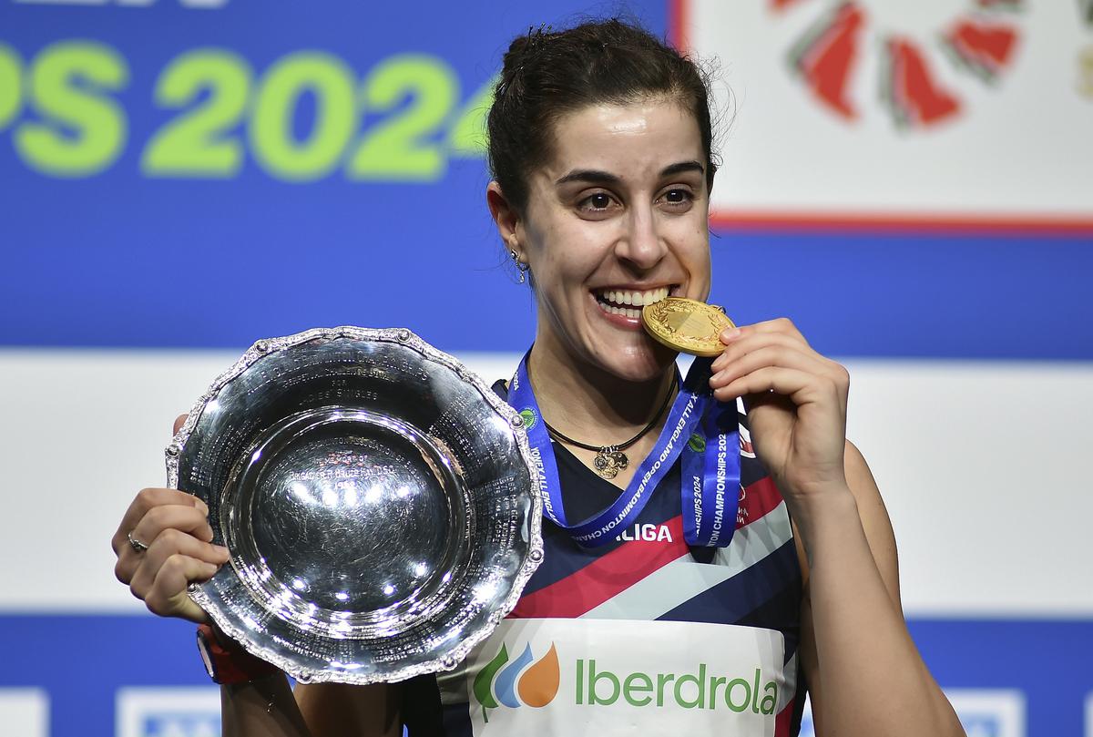 Spain’s Carolina Marin poses with the trophy after winning the women’s singles title.