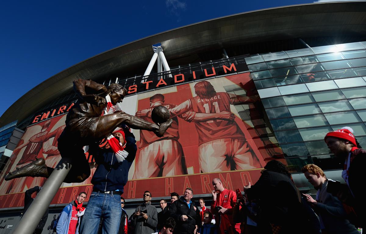 Fans of Arsenal enjoy the new former Arsenal and Netherlands footballer Dennis Bergkamp statue prior to the Barclays Premier League match between Arsenal and Sunderland at Emirates Stadium.