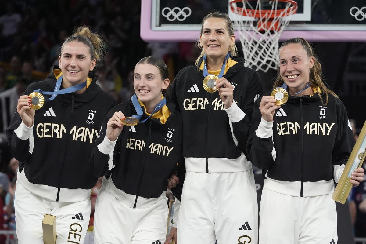 Germany’s women’s 3x3 basketball team celebrate their gold medals during the medal ceremony at the 2024 Summer Olympics.