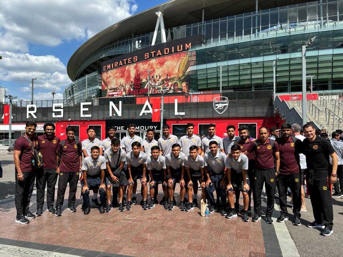 Punjab FC team and coaching staff poses for a photograph in front of Arsenal’s home ground, the Emirates Stadium in London. 