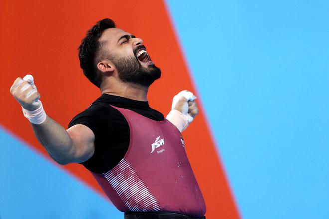 Vikas Thakur celebrates during the men’s weightlifting 96kg final on Tuesday. 