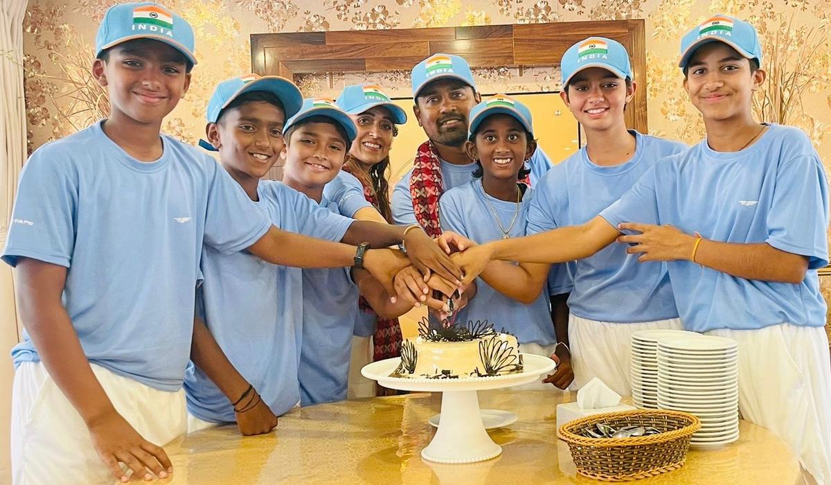 The Indian boys and girls teams with coaches Asha Sharma and Indra Kumar Mahajan celebrate their triumph in the South Asian under-12 tennis in Kathmandu, Nepal.