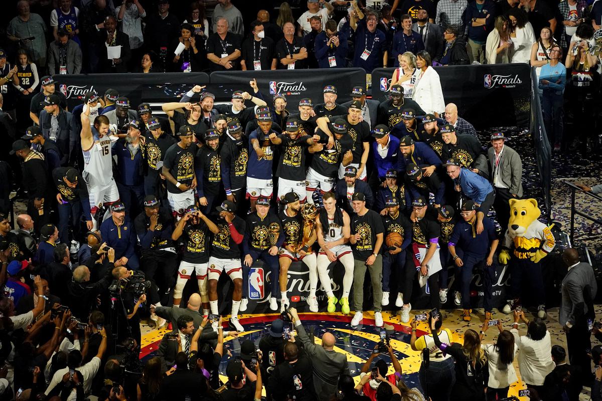 Team work: The Denver Nuggets celebrate after winning the 2023 NBA Finals against the Miami Heat at Ball Arena. 