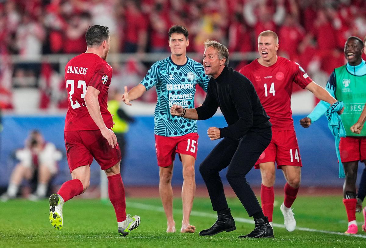 Denmark’s Pierre-Emile Hojbjerg celebrates scoring their first goal with head coach Kasper Hjulmand. 