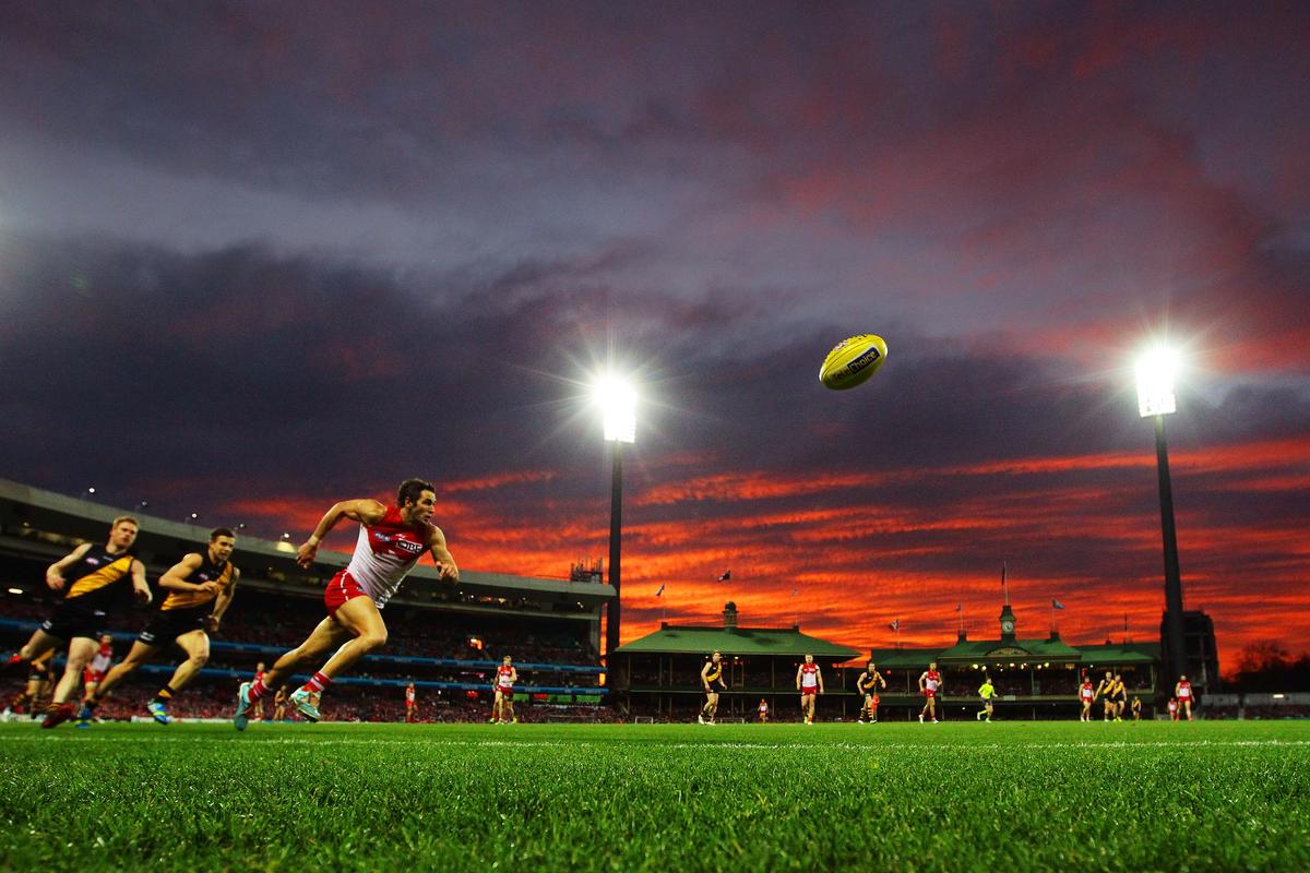 Aussie rules football is played Down Under and takes place in a lush green field that’s about 10 times bigger and uses a ball that becomes the centre of attention.