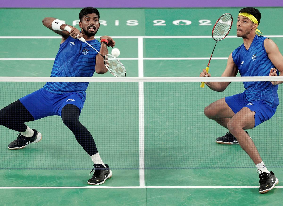 India’s Satwiksairaj Rankireddy (L) plays a shot in the men’s doubles badminton quarterfinal match at the Paris Olympics.