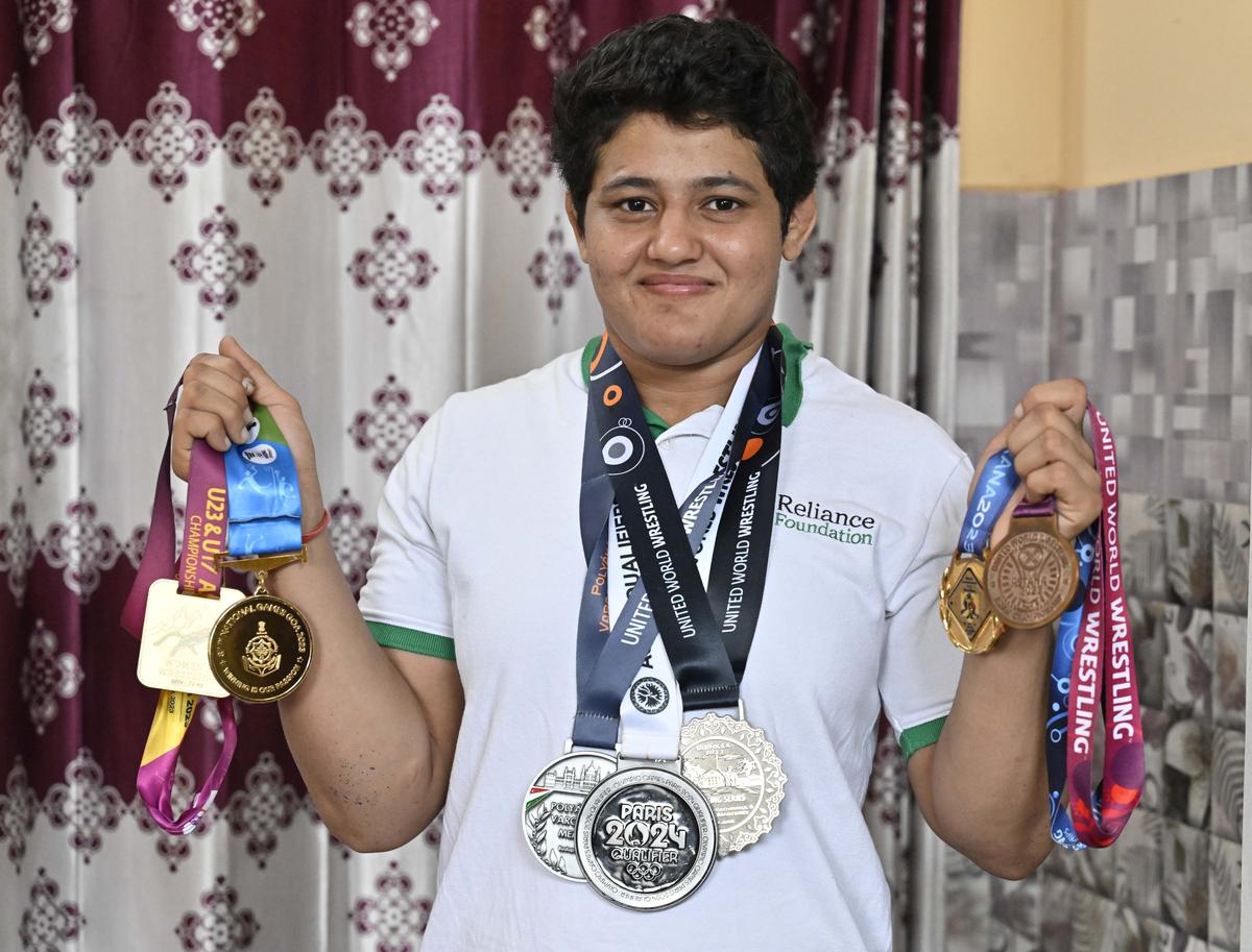 Pride of the family: Reetika poses with her medals.