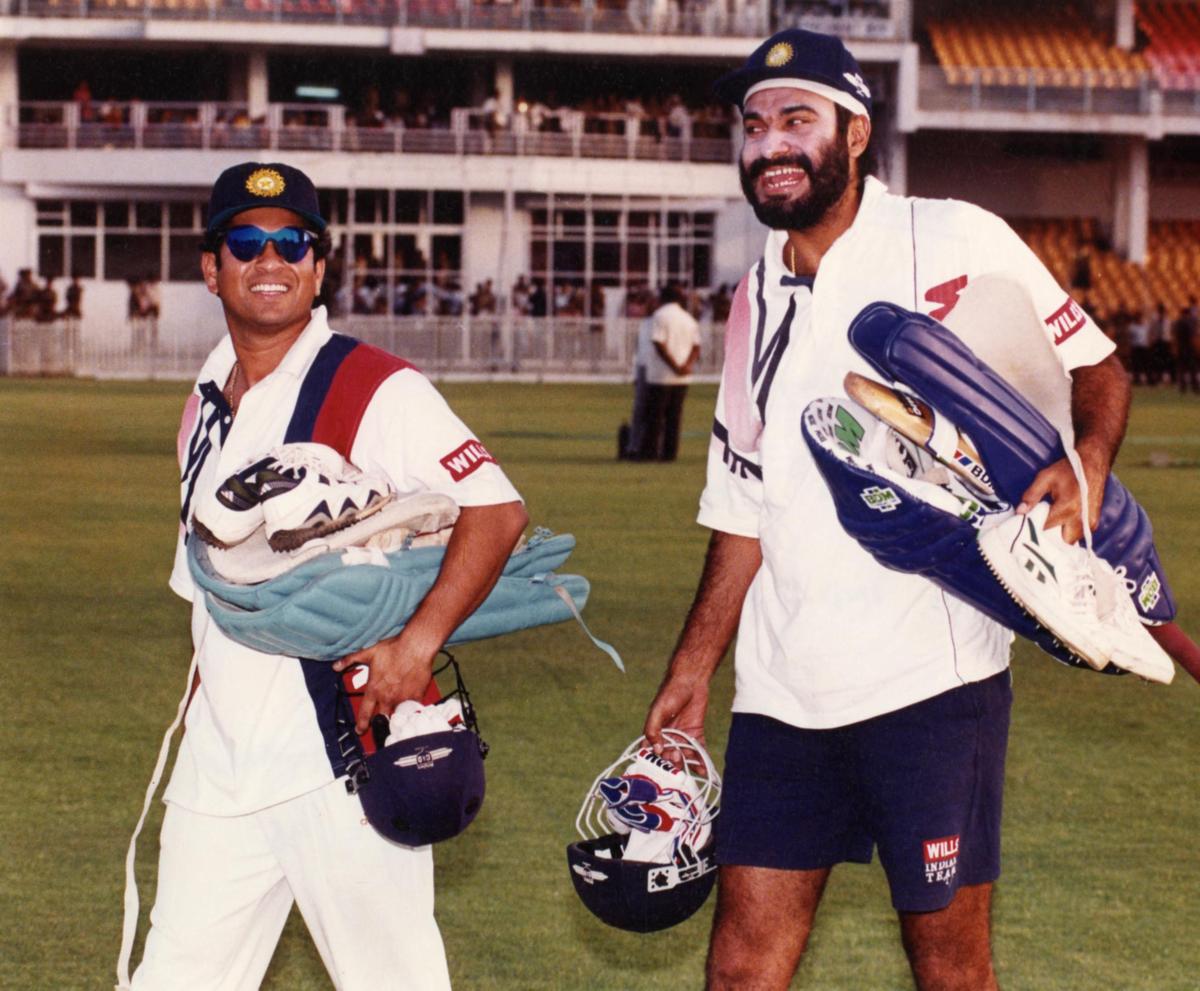 India's Sachin Tendulkar and Navjot Singh Sidhu share a joke during a practice session on the eve of the Coca Cola Triangular series One Day International cricket match between India and Kenya in Gwalior on May 27, 1998. 
