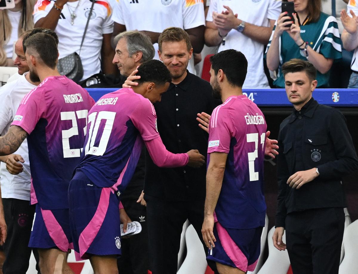 Germany coach Julian Nagelsmann celebrates with Jamal Musiala and Ilkay Gundogan after winning against Hungary. 