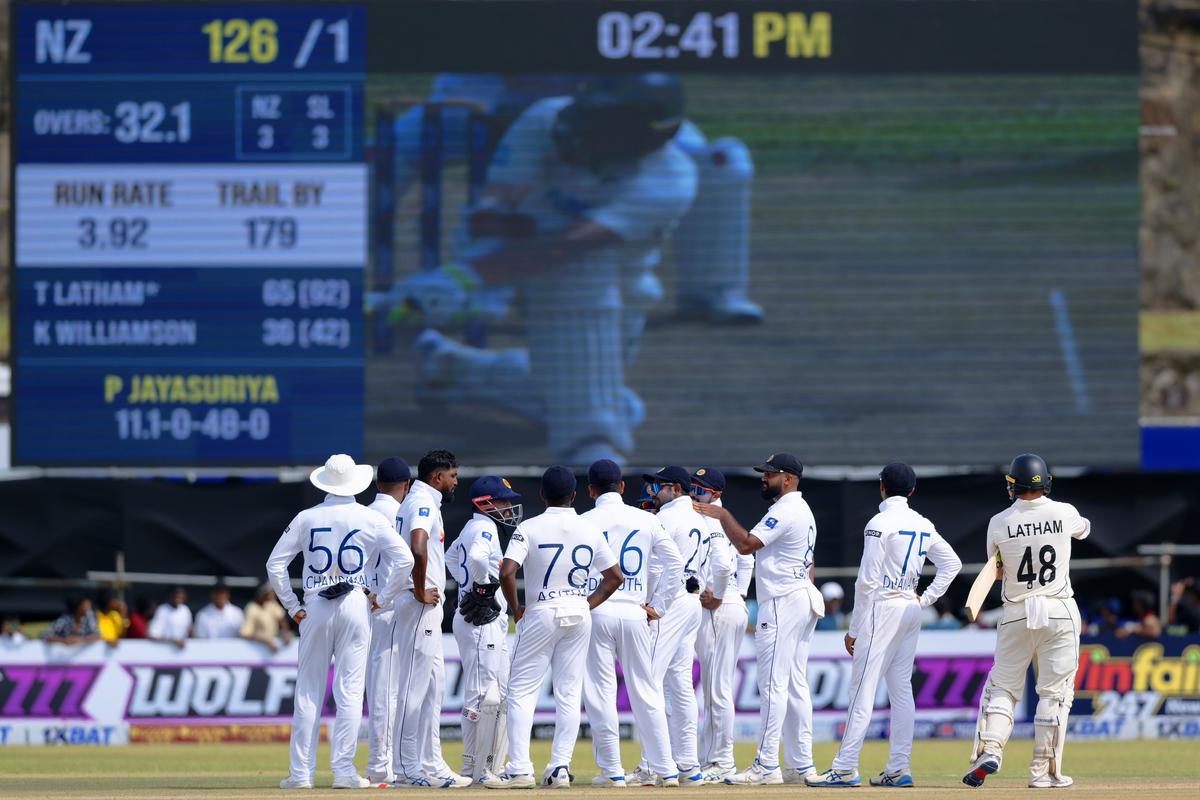 Sri Lanka players await the third umpire's decision on the LW appeal against New Zealand's Tom Latham. 