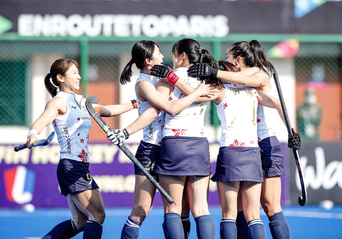 Japan players celebrate after scoring a goal against Chile.